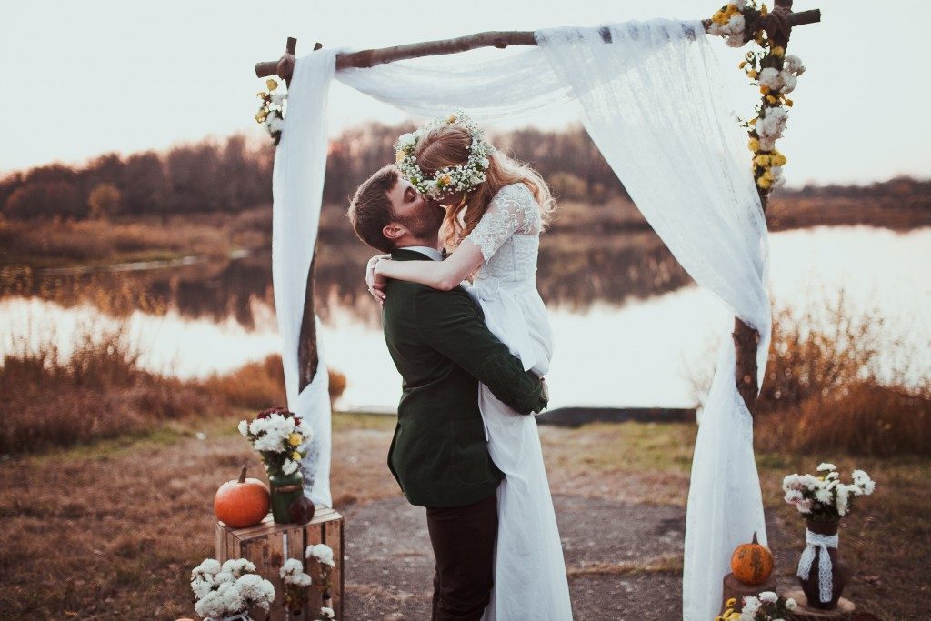 Bride and groom kissing after wedding