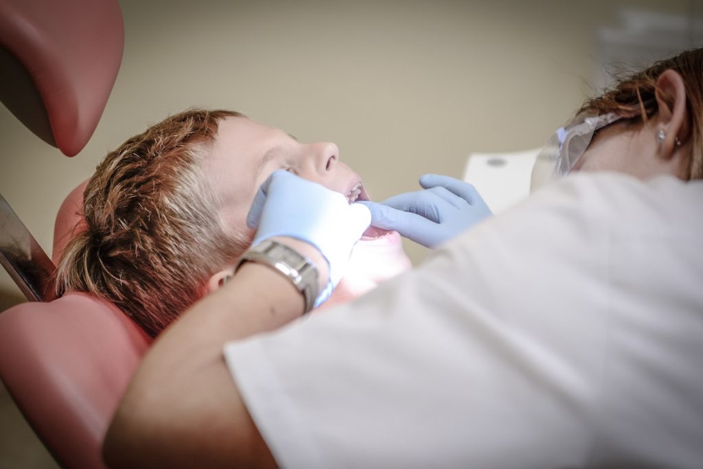 dentist checking up a boy